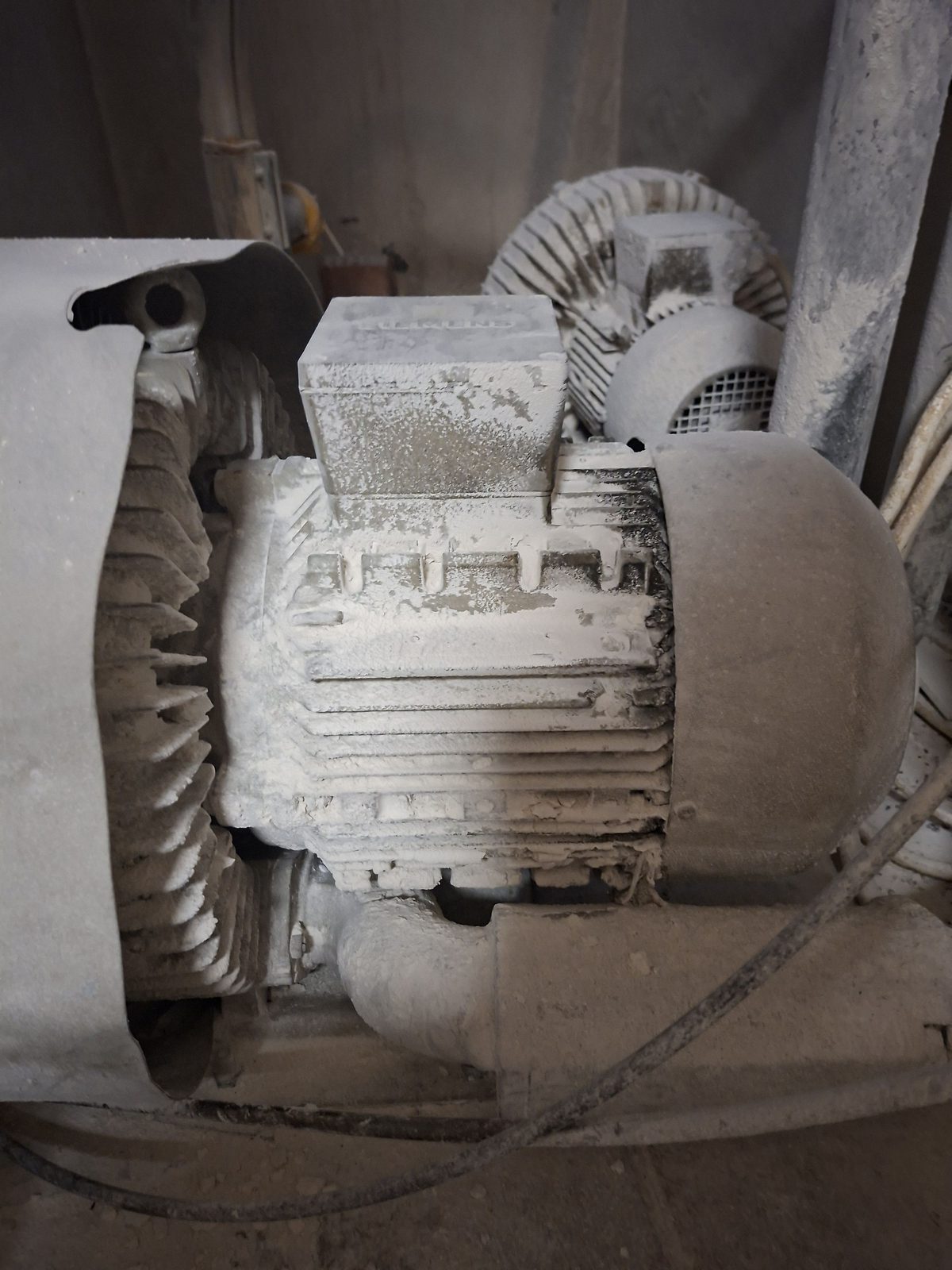 Dust build-up on an electric motor (combustible dust explosion risk)