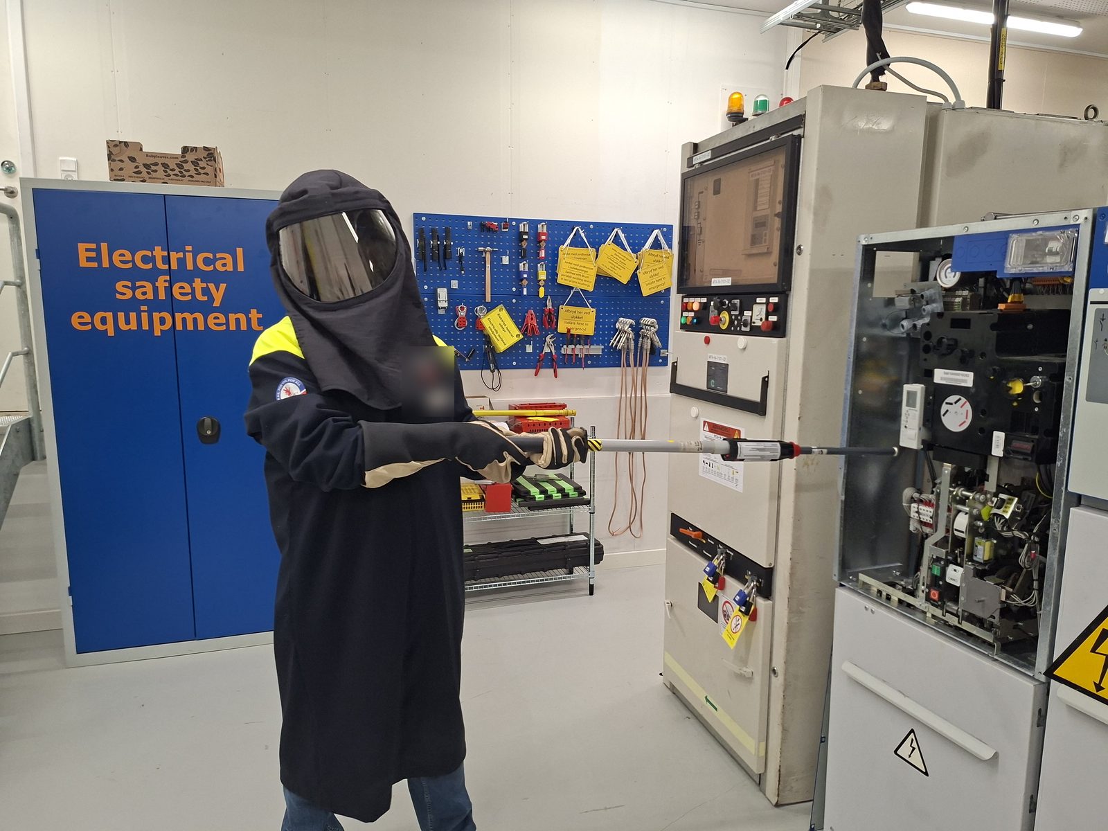 Hire a CompEx Technical Expert Absence-of-voltage testing on HV switchgear in arc-flash PPE